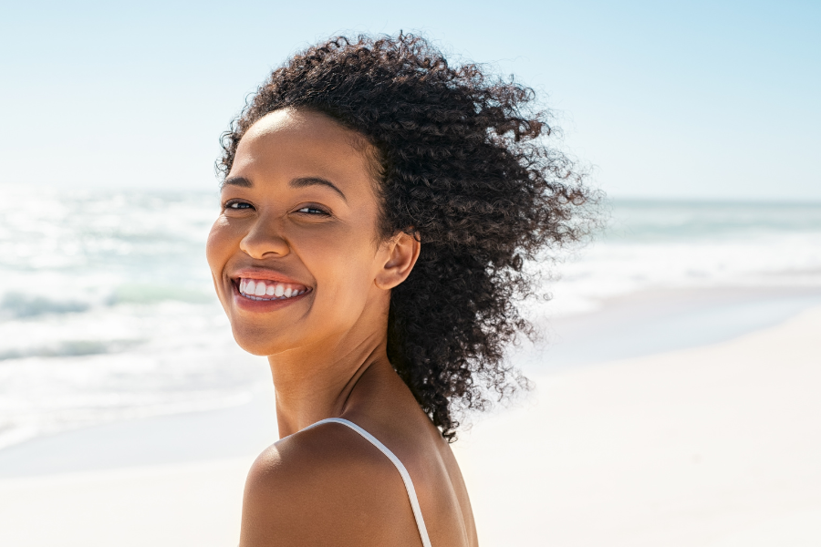Woman at beach near shore smiling